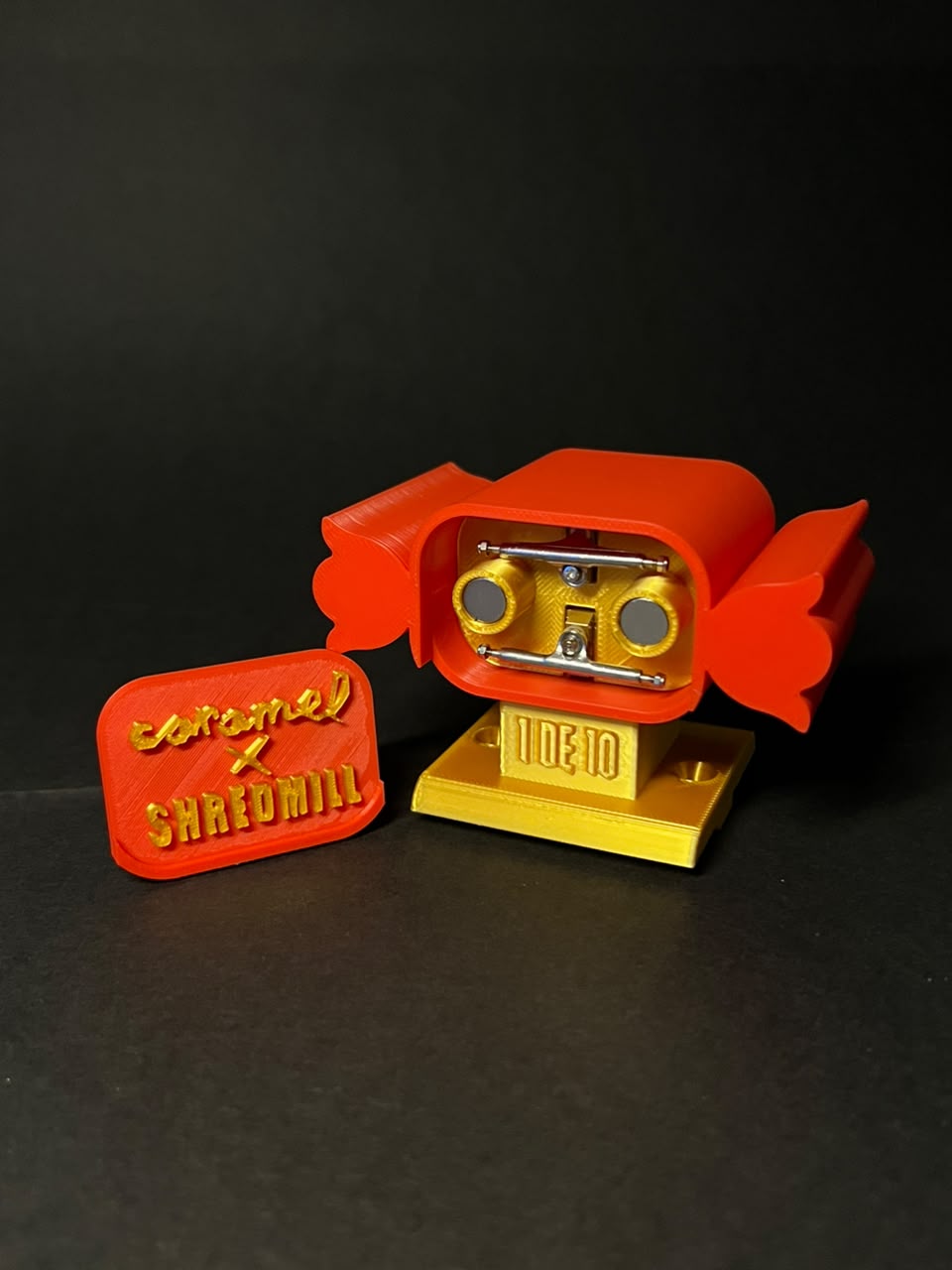 Open Caramel × Shredmill piece with the lid beside it and components visible