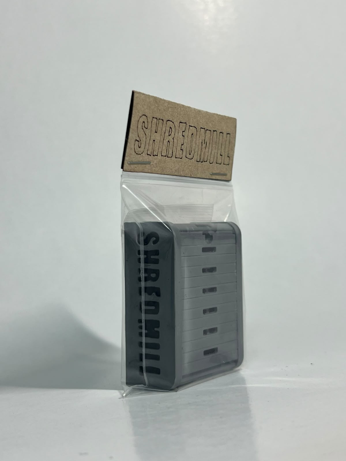 Front view of the packaged Shredmill keychain