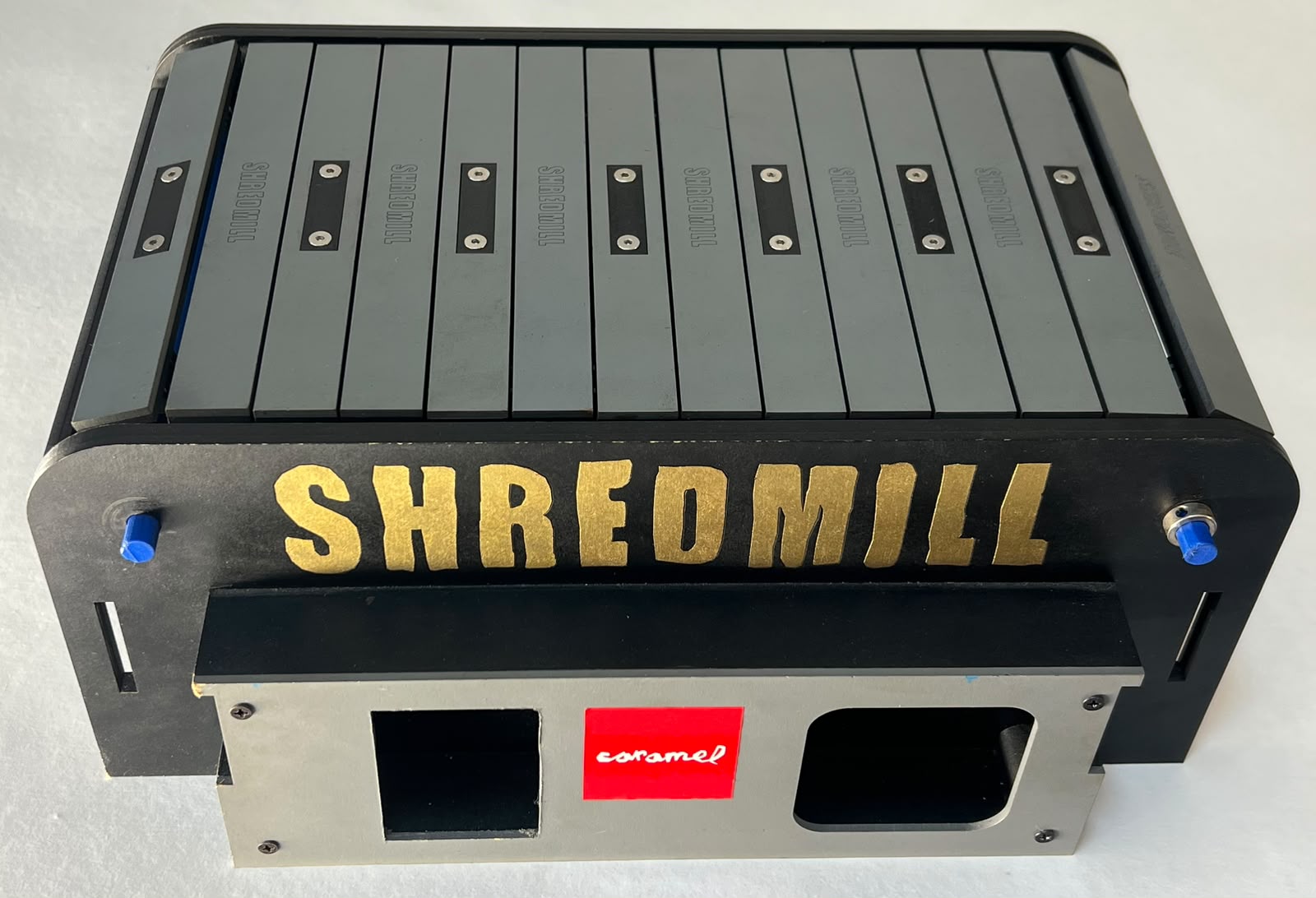 Elevated front view of Shredmill with a gray surface and gold lettering